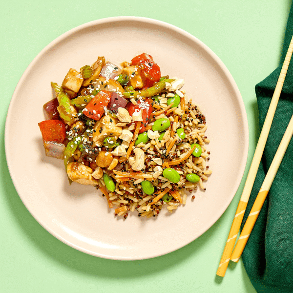 A healthy and gluten-free cashew chicken meal, freshly prepared for lunch or dinner, perfect for enjoying with chopsticks.