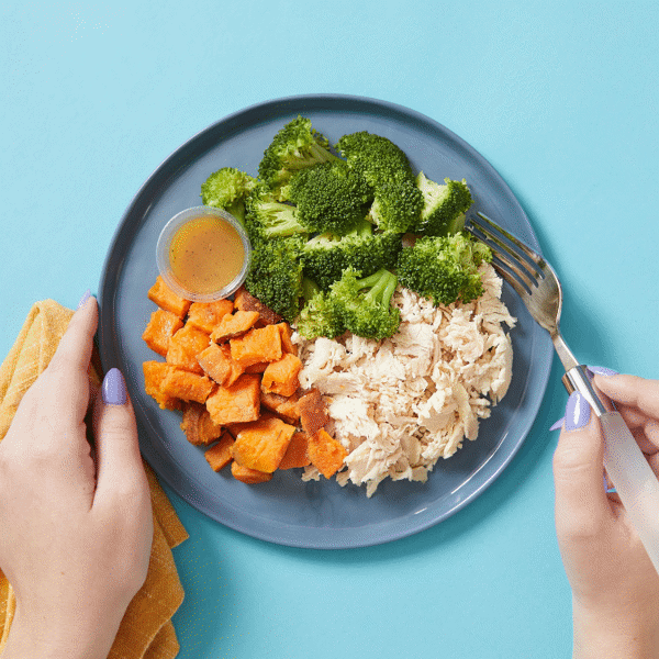 Meal with Supercharged Chicken—grilled all-natural chicken, roasted sweet potatoes, and steamed broccoli in a citrus glaze.