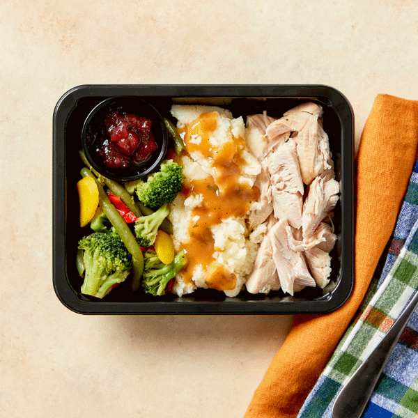 Nutritious Meal Prep—succulent Classic Roasted Turkey, creamy mashed potatoes, tangy cranberry relish, and rich turkey gravy.