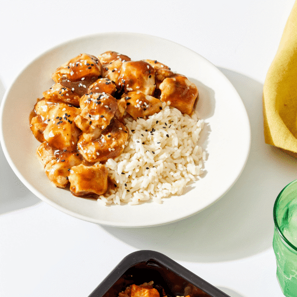 Fitlife Foods' chicken is marinated in a blend of green onions, soy sauce, and brown sugar and served over rice with sesame seeds.