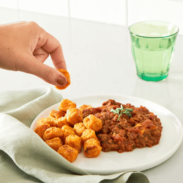 Lean ground beef flavored with a blend of fresh tomato sauce and honey, paired with savory sweet potato tots is a freshly made lunch