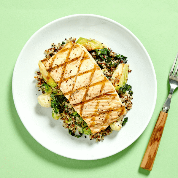 Simply Grilled Salmon, rich in omega-3, paired with quinoa and a medley of roasted Brussels sprouts, cauliflower, and kale.