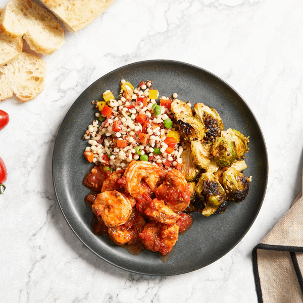 A healthy lunch with Fitlife Foods' Shrimp Diavolo with a side of fresh vegetable-packed pilaf and roasted Brussels sprouts