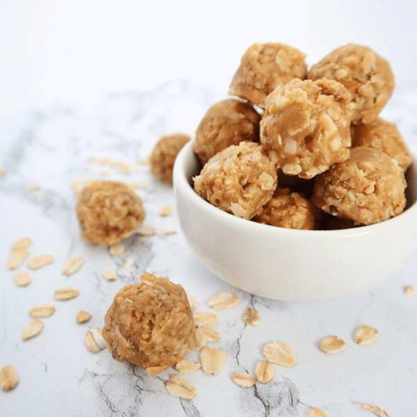Golden brown Peanut Butter Oat Crunch balls in a white bowl are Dairy-Free, Low-Carb, Gluten-Free, and Vegetarian treats