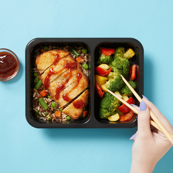 Nutritious meal with chef-crafted Chicken Katsu, rice, quinoa, and fresh veggies—a healthy lunch ready to eat in a microwavable container