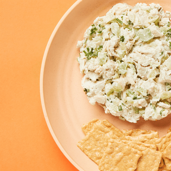 A close-up of Gluten-Free, Dairy-Free, and Low-Carb Tarragon Chicken Salad accompanied with crackers for a healthy meal prep