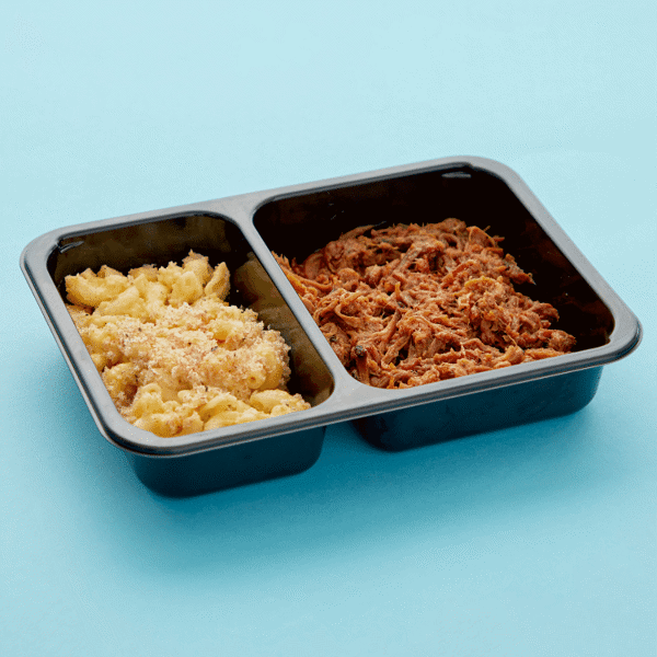 Healthy prepared meal – BBQ beef brisket with a side of butternut and cheddar baked mac 'n cheese packaged in a microwave-safe container