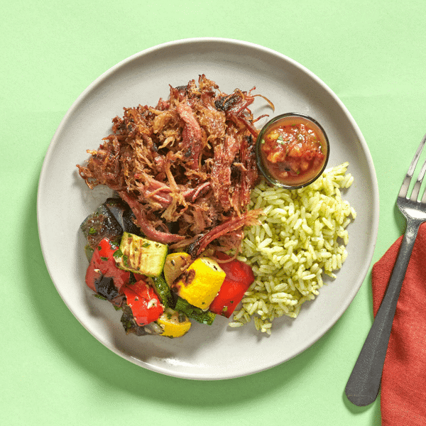 Low Carb Pulled Pork Carnitas—smoked pork on cilantro lime brown rice, topped with roasted pineapple salsa and fire-roasted veggies