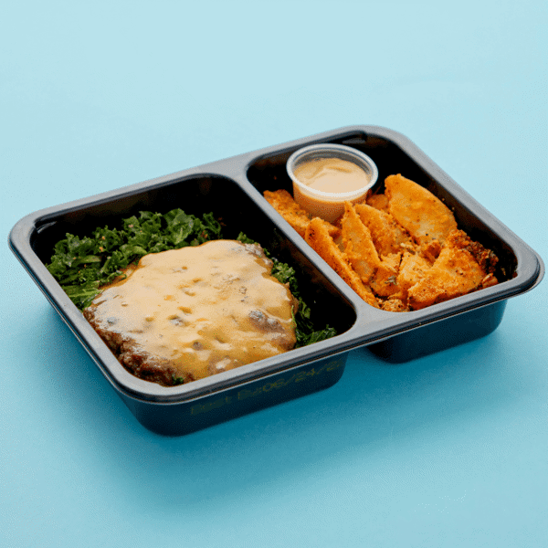 Bun-free and gluten-free burger with kale and cheddar served with a side of seasonal potato wedges and a secret sauce in a microwavable box