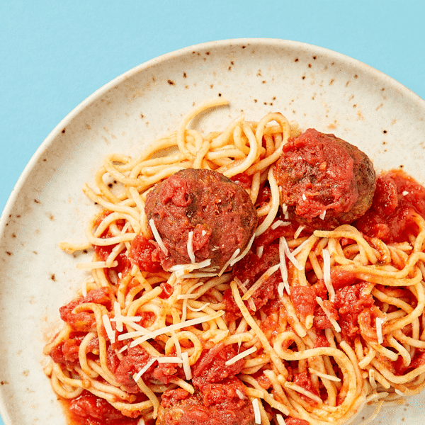 A close-up of nutritious plant-based meal prep featuring Vegetarian Beyond Beef sausage mixed with parmesan and fiber-rich Barilla spaghetti