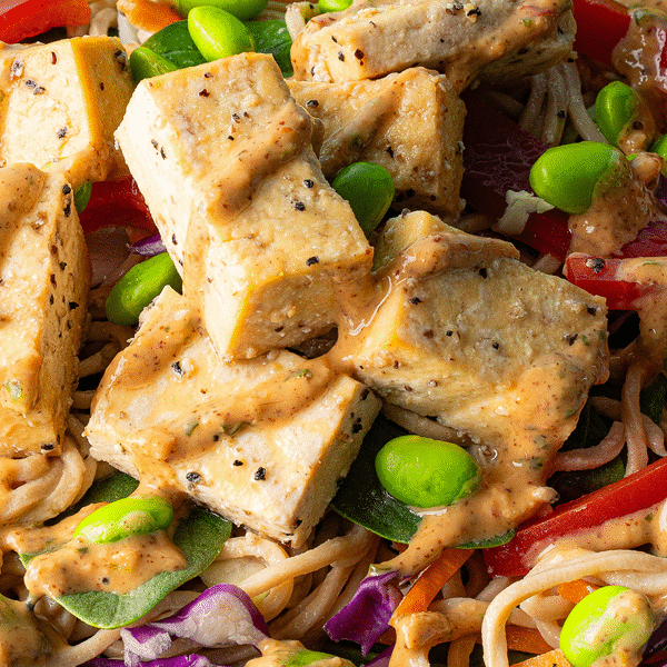 Close up of tofu with sauce on a Vegan Yakisoba Noodle Salad